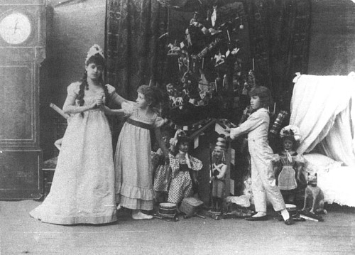 A photograph from the original 1892 premiere production of Tchaikovsky's The Nutcracker at the Imperial Mariinsky Theatre, showing child performers in period costume around a Christmas tree