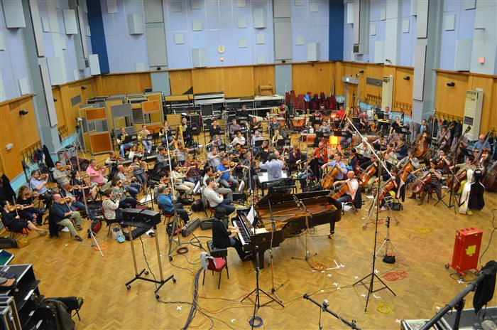 The London Symphony Orchestra recording a film score in Abbey Road's Studio 1, with a full string section, piano, and microphones set up