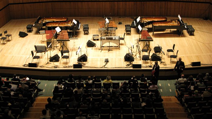 The mirrored stage setup for Steve Reich's Music for 18 Musicians, showing paired pianos, marimbas, and a vibraphone