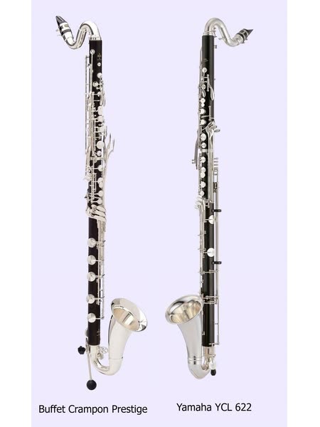 Two modern bass clarinets standing side by side, black wooden bodies with silver keys, a curved silver neck at the top and an upturned silver bell at the bottom