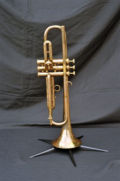 A brass trumpet on a stand